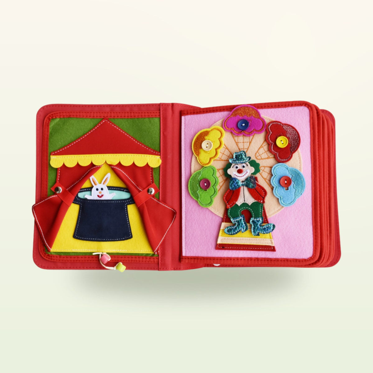 Circus Adventure quiet book magician double page with rabbit in the top hat and clown with felt flowers to button on, on a soft cream background – from 3 years