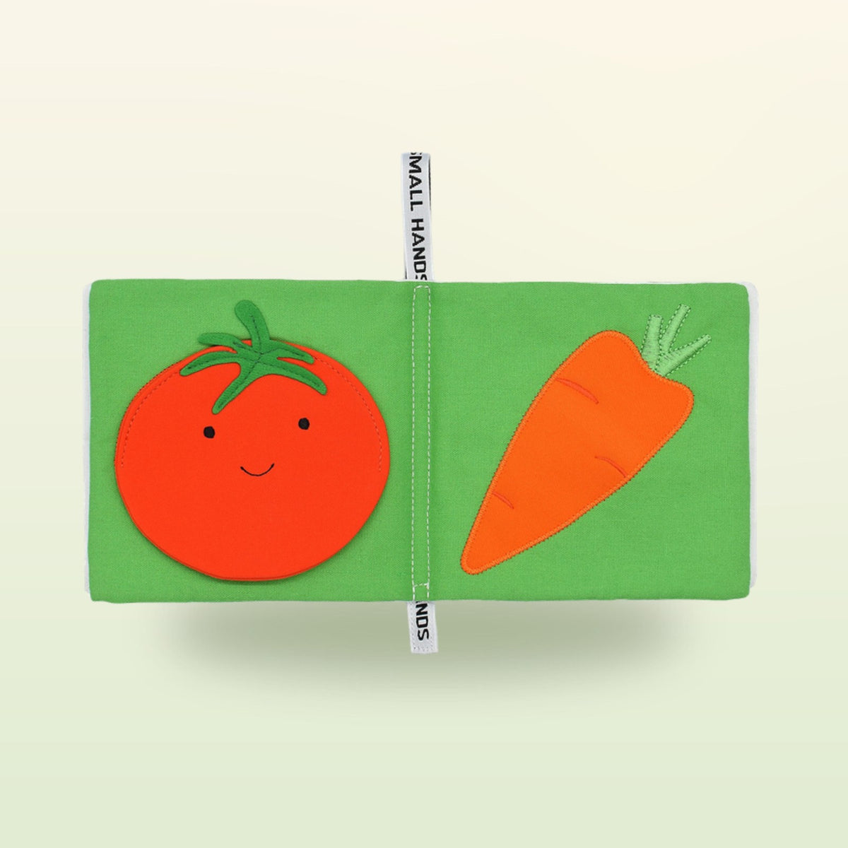 Small Hands Vegetables Montessori cloth book double page with tomato and carrot on a soft meadow green background – from 1 year