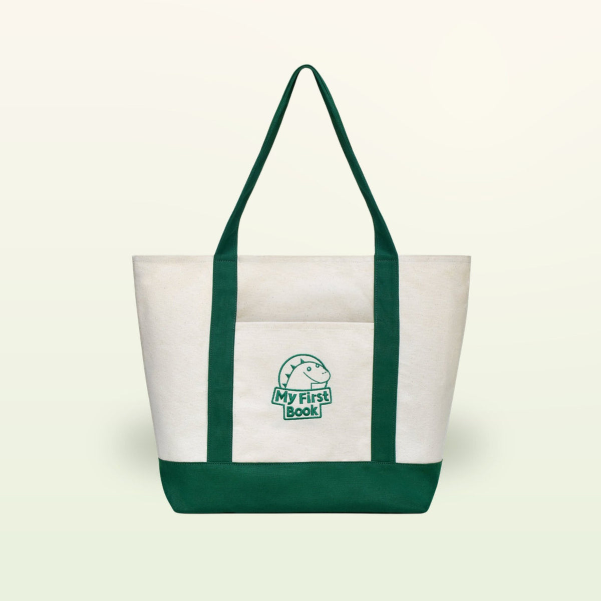 My First Book tote bag – cream fabric bag with green handles, front view on a soft cream background