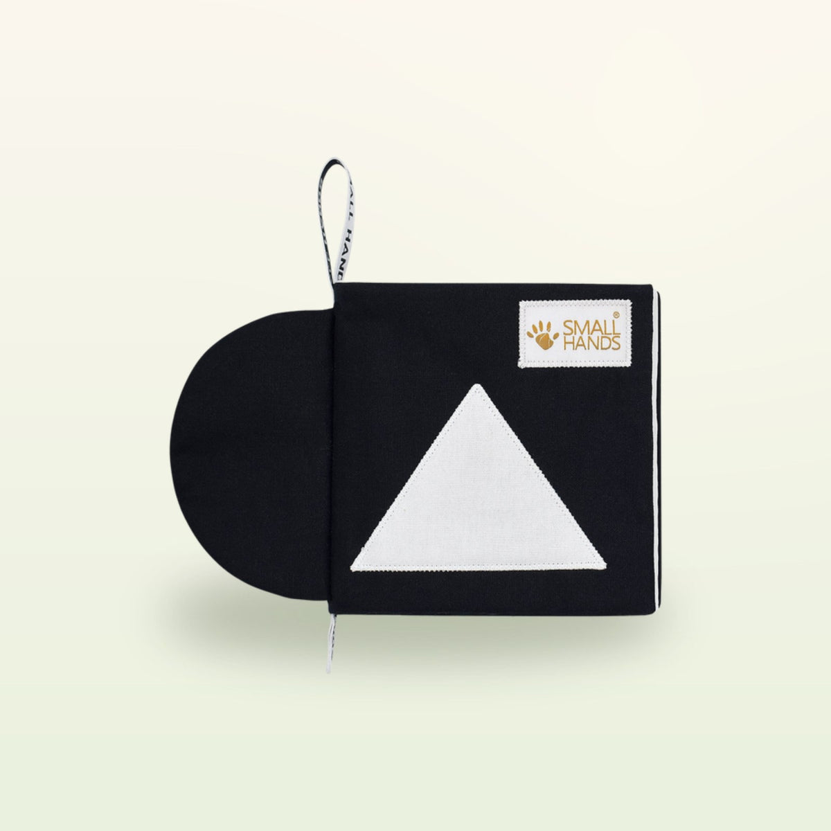 Small Hands Shapes Montessori contrast book – black cover with white triangle on a soft cream background – from 0 months