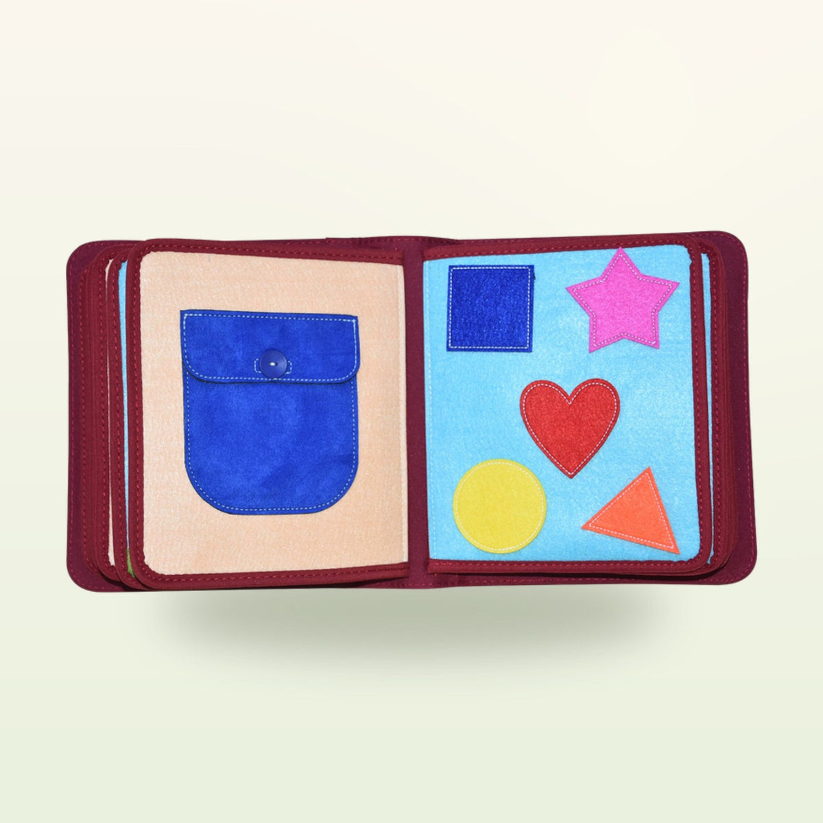 My Everyday quiet book shapes double page with felt star, heart, circle, square and triangle and press-stud pocket on a soft cream background – from 1 year