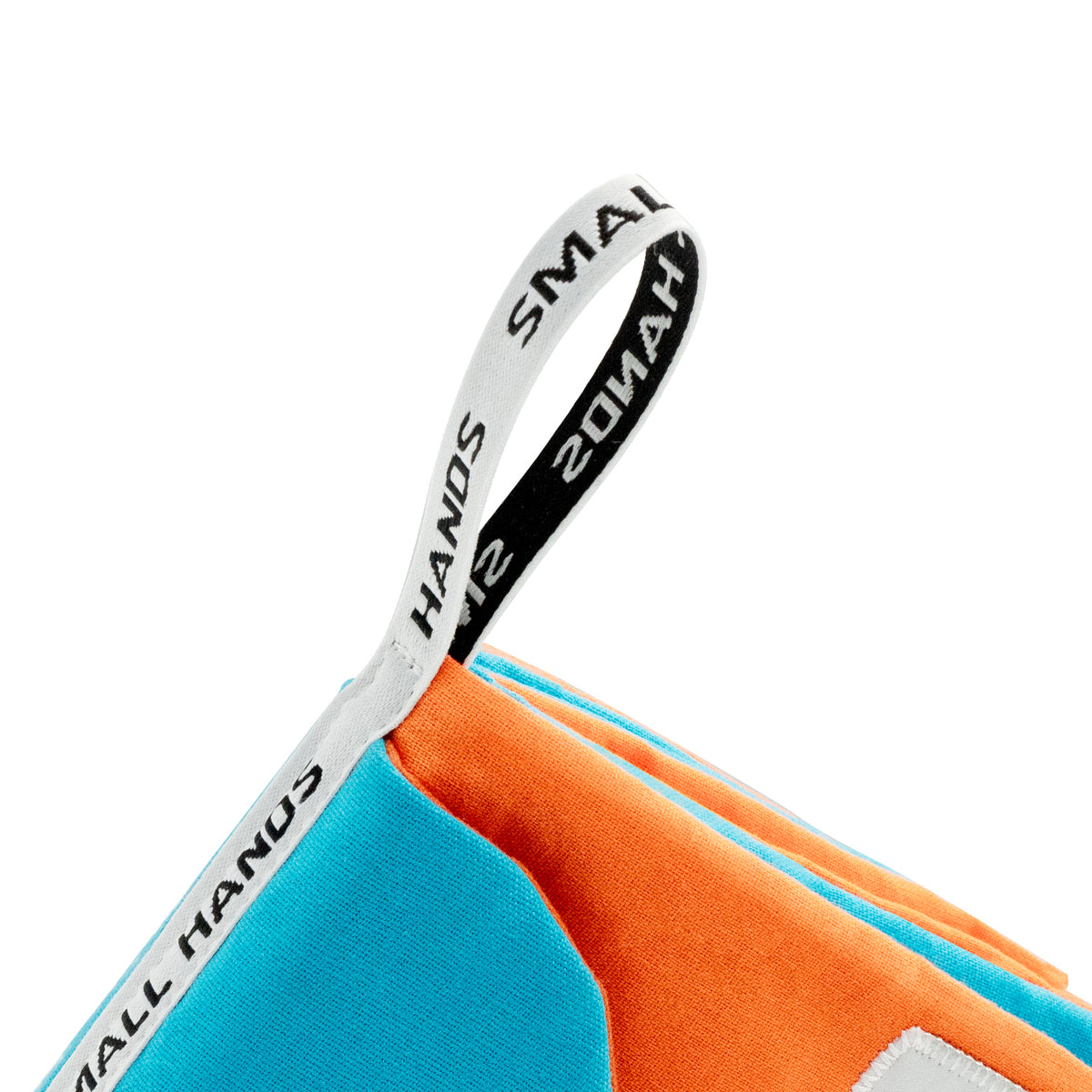 Pets Montessori sensory cloth book by Small Hands – close-up of the printed SMALL HANDS fabric hanging loop on the orange and blue corner of the book