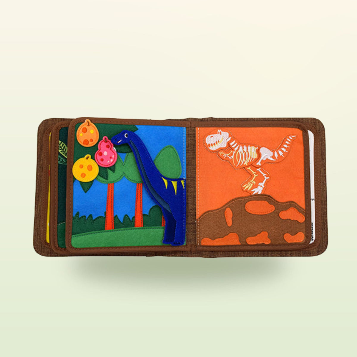 T-Rex quiet book page with long-necked dino, fruit on the tree and dino skeleton on a soft jungle-green background – from 1 year