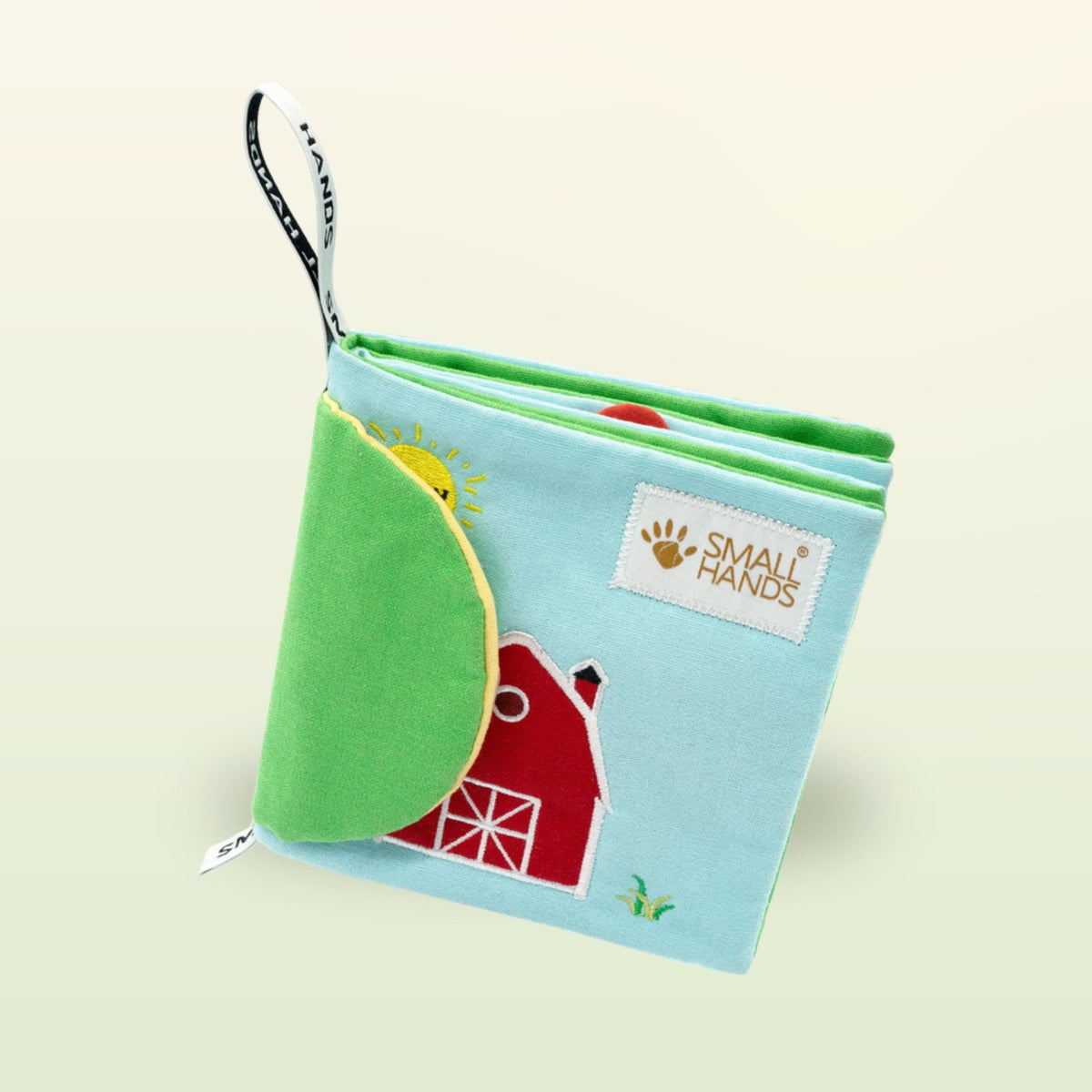 My First Book Small Hands Farm cloth book standing with hanging loop on a soft meadow green background – from 0 months