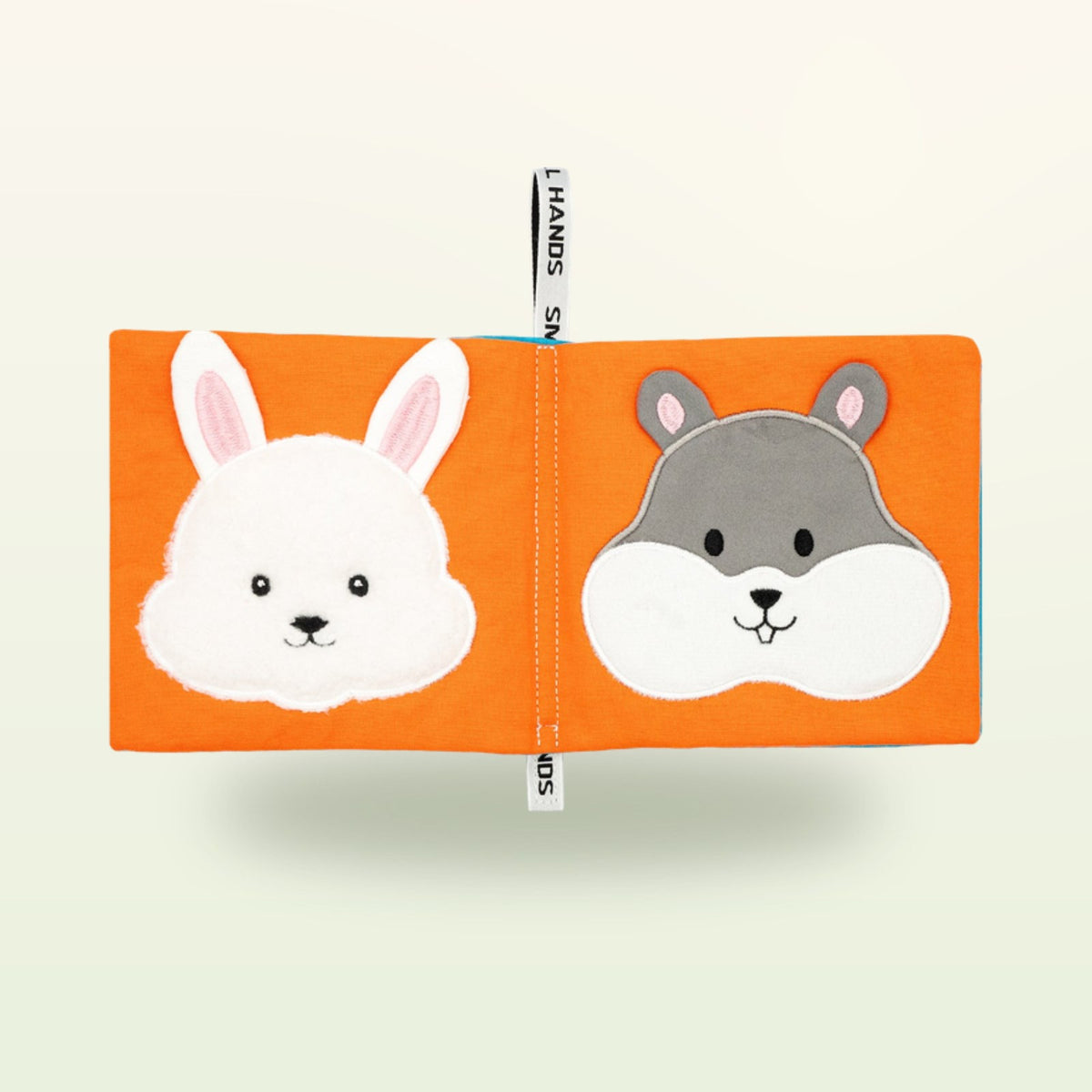 Small Hands Pets Montessori cloth book open – white rabbit and grey hamster on a soft cream background – from 0 months