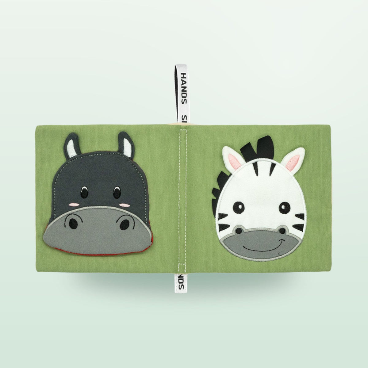 Small Hands Animals of Africa Montessori cloth book double page with hippo and zebra on a soft forest green background – from 0 months