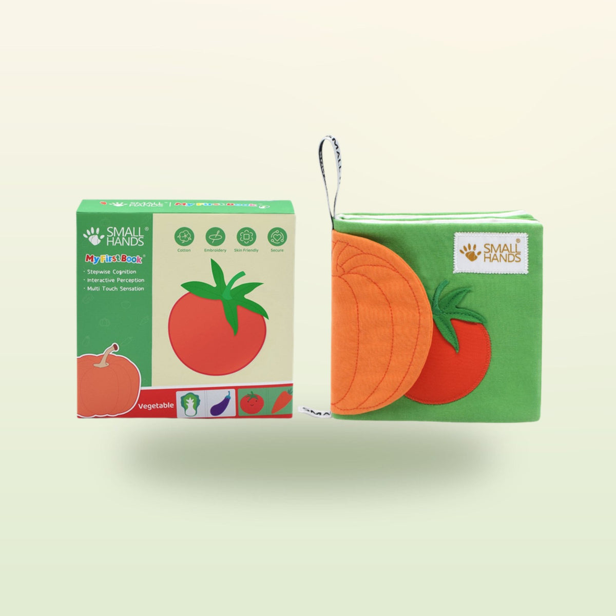 Small Hands Vegetables Montessori cloth book with packaging on a soft meadow green background – from 1 year
