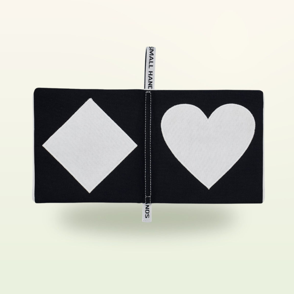 Small Hands Shapes contrast book open – white diamond and large heart on a soft cream background – from 0 months
