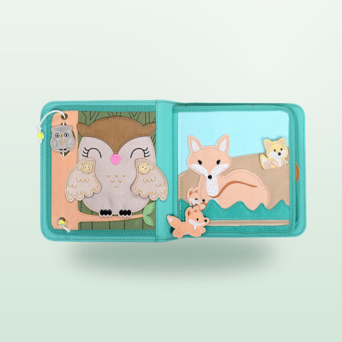 Nordic Forest quiet book felt pages with a large owl with button wings and mother fox with her cubs on a soft forest background – from 1 year