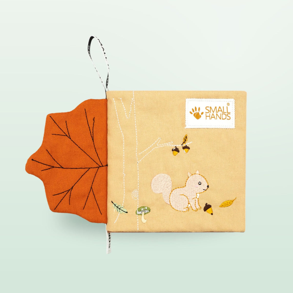 Small Hands Wild Animals sensory cloth book cover with squirrel and touchable maple leaf on a soft forest green background – from 0 months