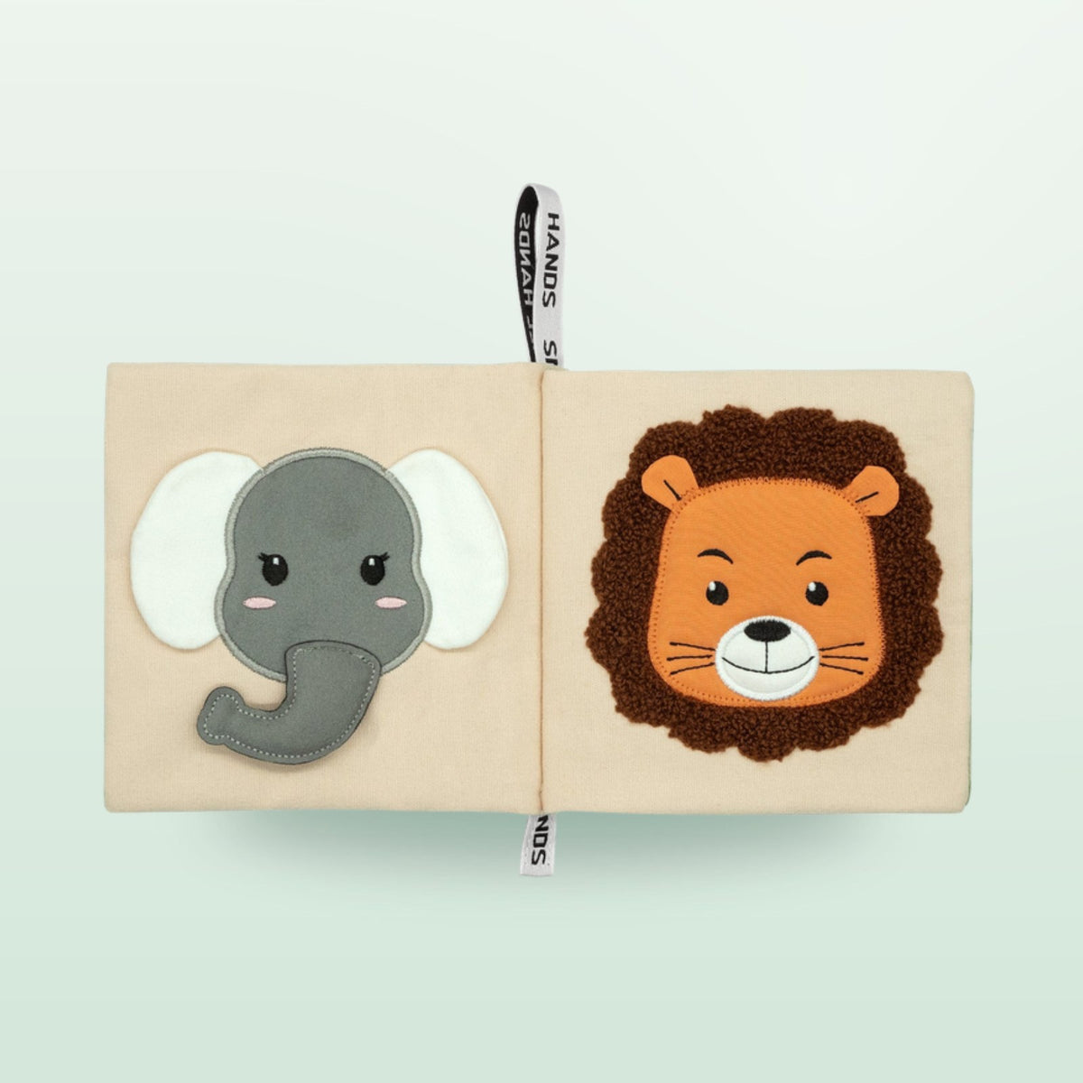 Small Hands Animals of Africa Montessori cloth book double page with elephant and lion on a soft forest green background – from 0 months