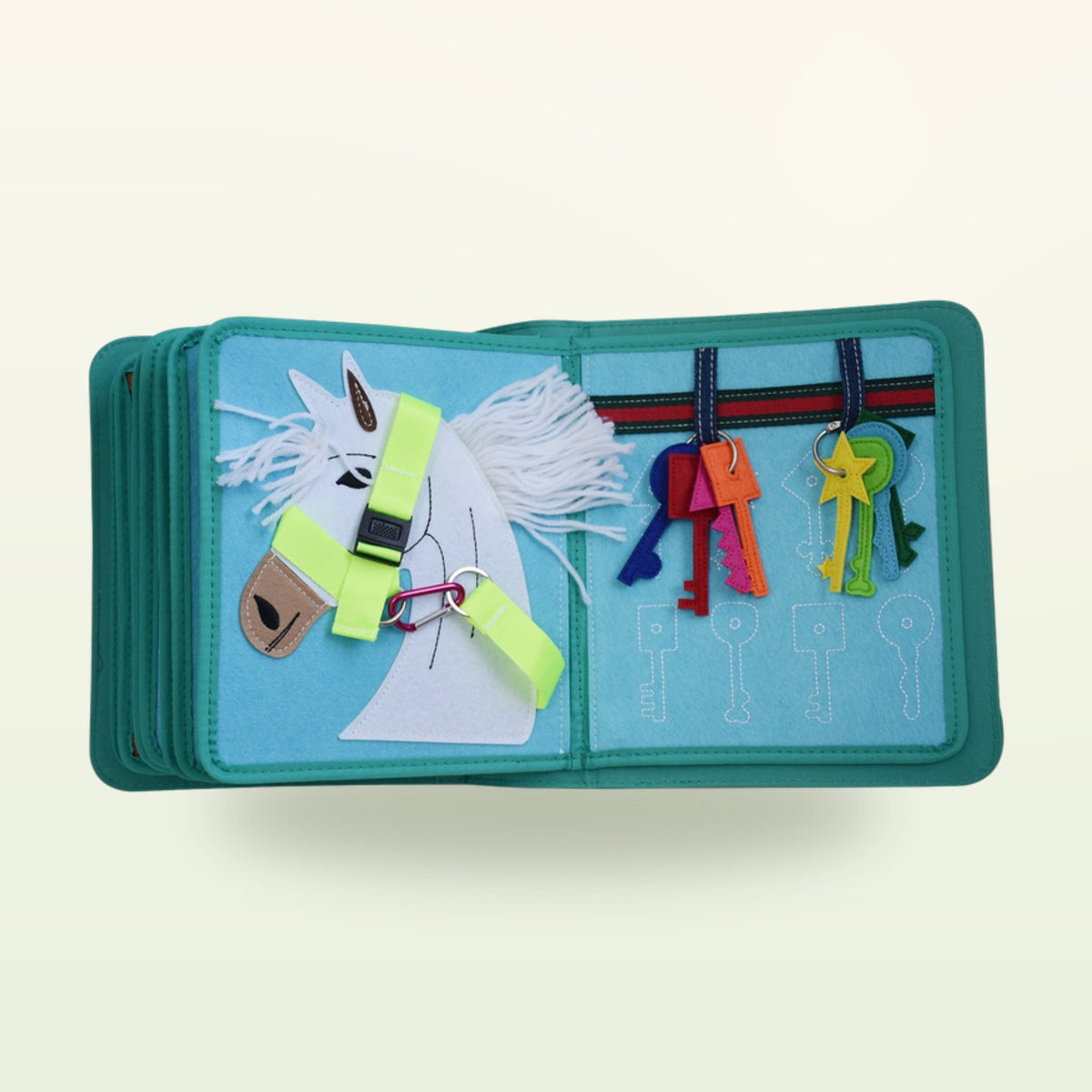 Dressing book fabric page with horse head with halter buckle and colourful keys to match on a soft cream background – from 3 years