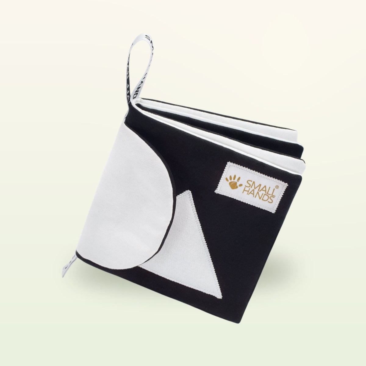 Small Hands Shapes black and white book from the side – soft fabric pages with circle and triangle on a soft cream background – from 0 months