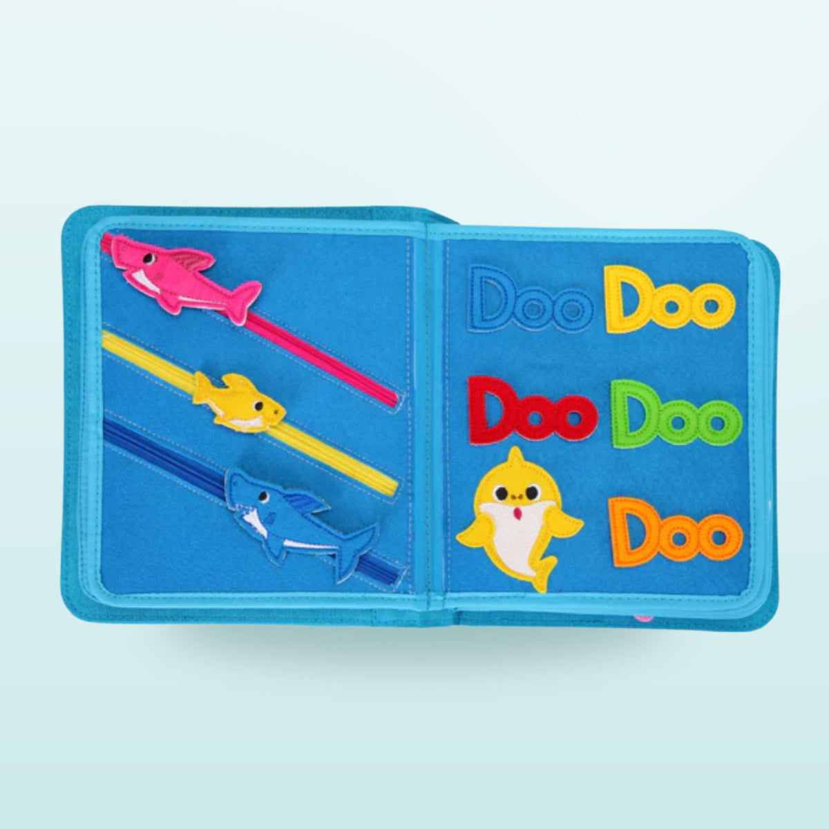 Baby Shark quiet book double page with sliding sharks and colourful Doo-Doo-Doo letters on a soft sea background – colours and fine motor skills from 3 years