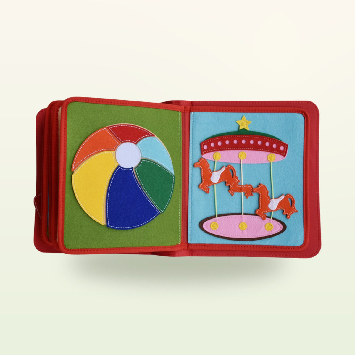 Circus Adventure quiet book double page with multicoloured ball for learning colours and carousel with horses on a soft cream background – from 3 years