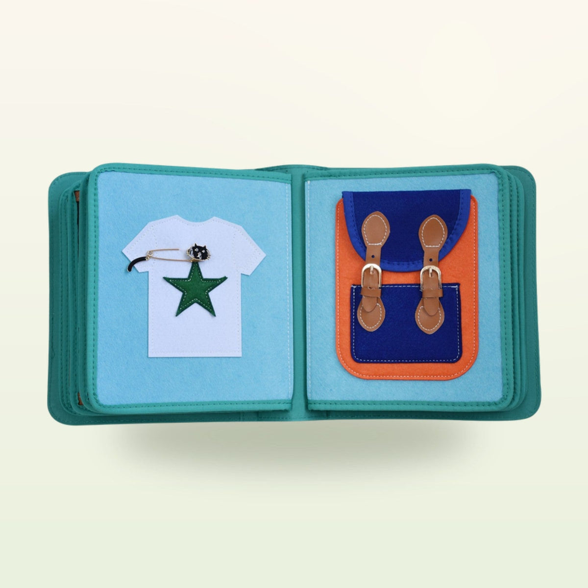 Dressing book fabric page with white T-shirt with star appliqué and backpack with buckles on a soft cream background – from 3 years