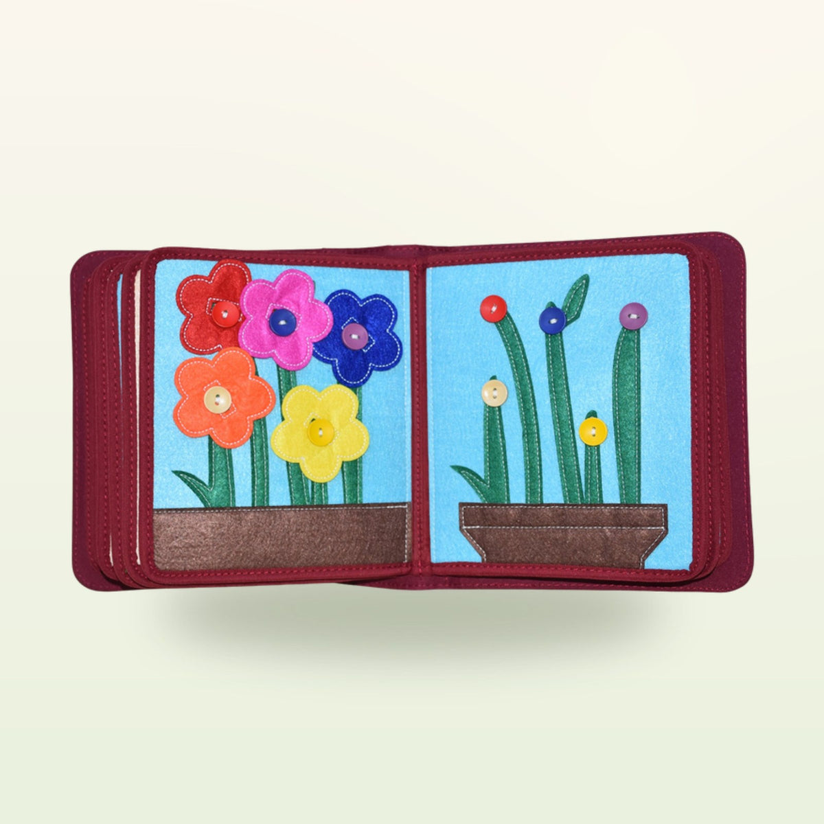 My Everyday quiet book flower double page with colourful felt flowers to button onto the green stems on a soft cream background – from 1 year