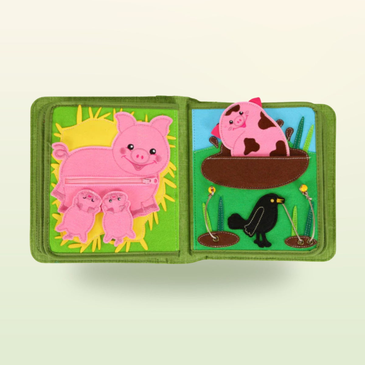 Farm quiet book page: pig with a zip on its belly and little piglets – on a soft meadow background