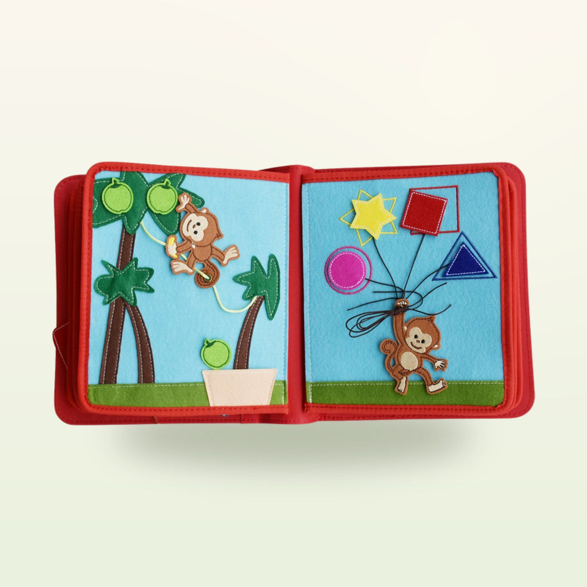 Circus Adventure quiet book jungle double page with monkey to slide back and forth and felt shapes on strings on a soft cream background – from 3 years