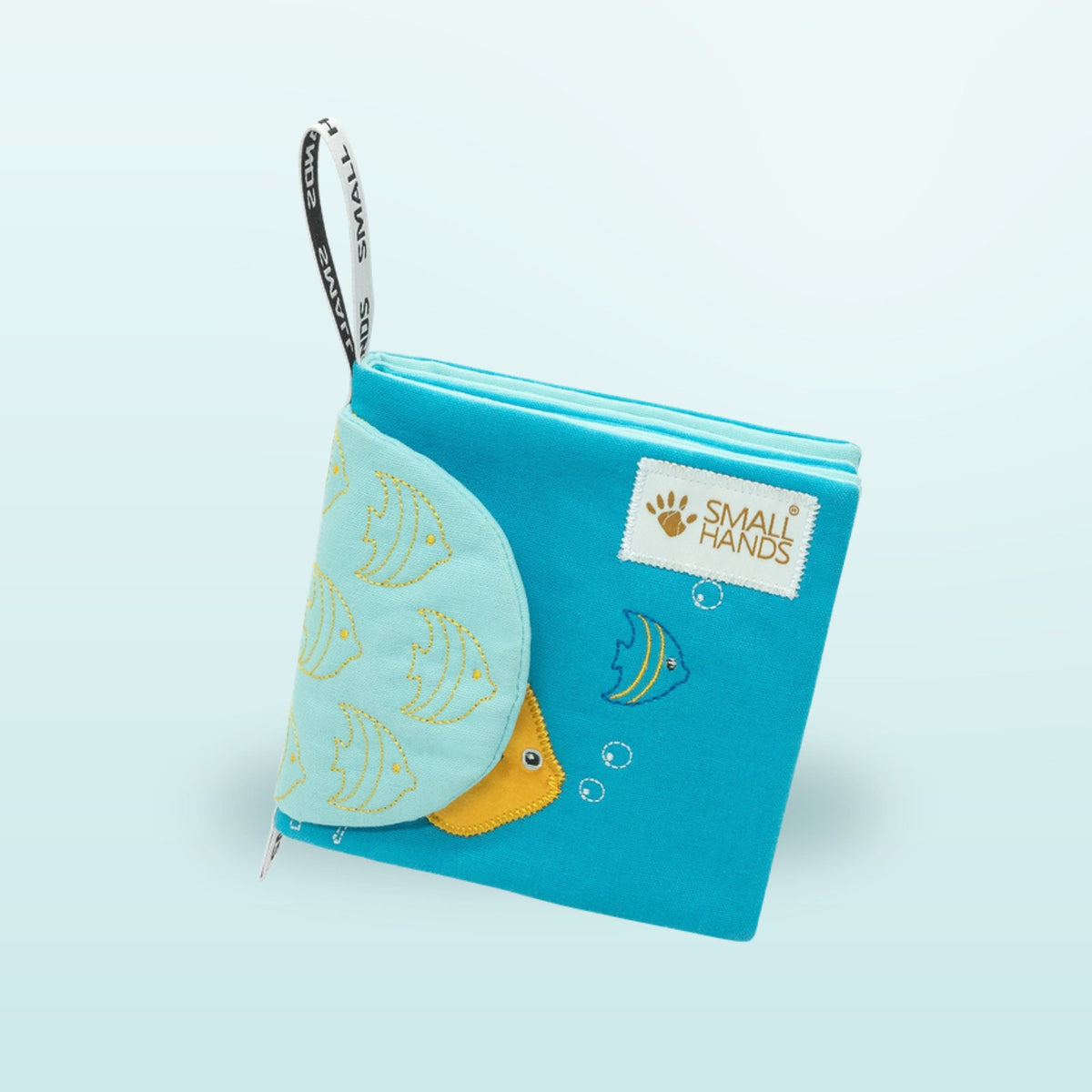 Small Hands Sea Animals Montessori cloth book standing with hanging loop on a soft underwater blue background – from 1 year