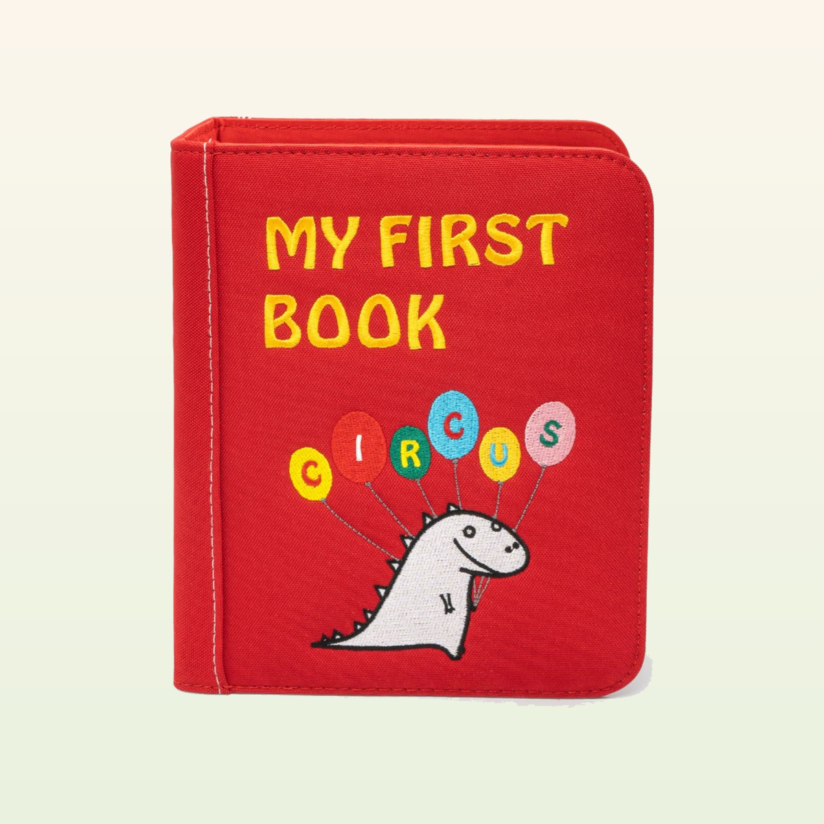 Circus Adventure quiet book closed – red MY FIRST BOOK Circus cover with dino on a soft cream background