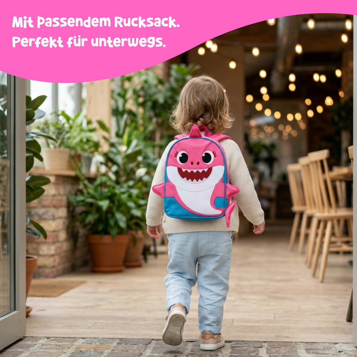 Toddler carrying the pink Mama Shark backpack out and about – quiet book with matching backpack from 3 years