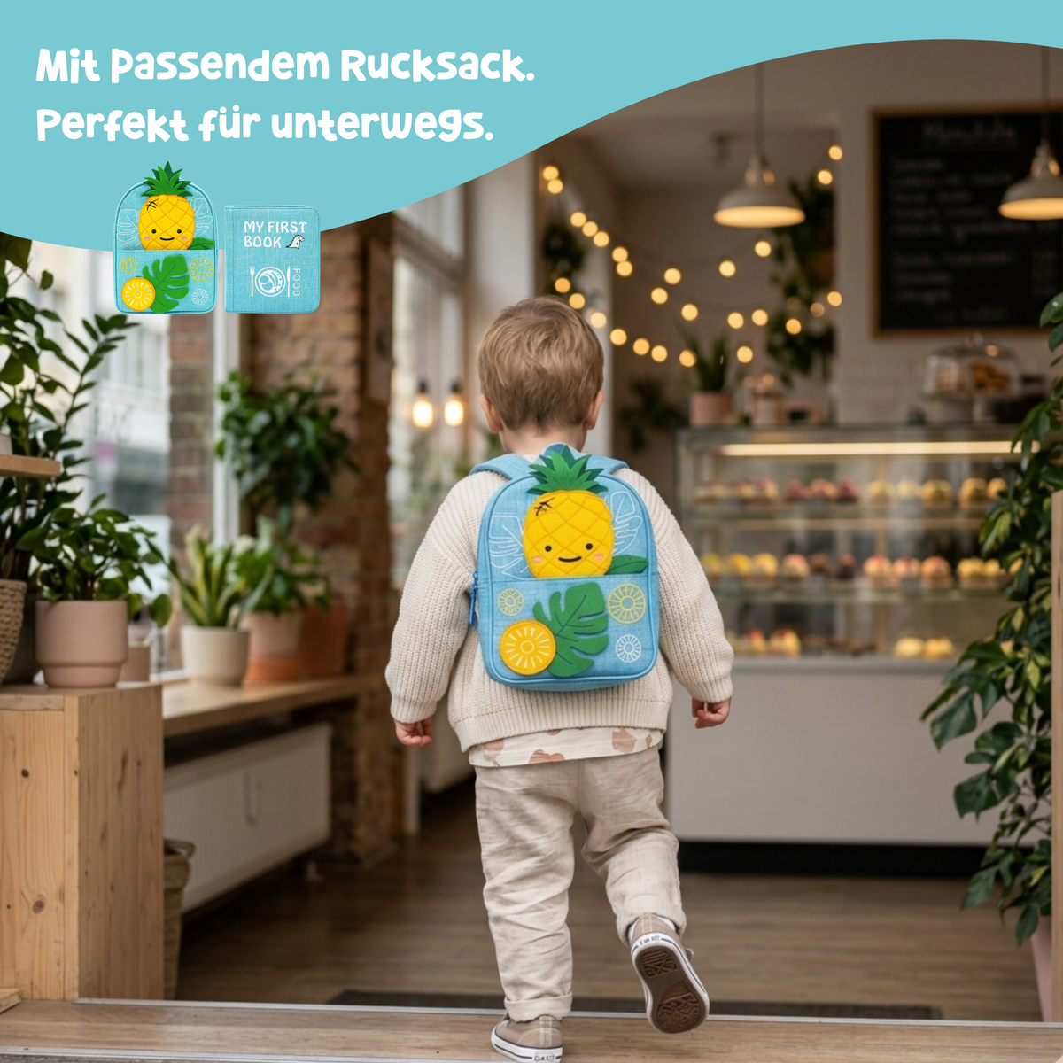 Little Foodies Montessori quiet book with matching backpack – complete set: toddler carrying the light blue pineapple backpack in a café, fabric book for on the go from 1 year