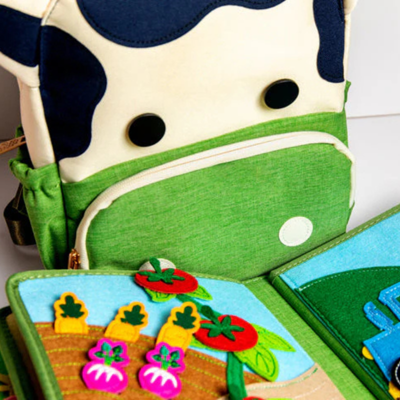 Page of the Montessori farm quiet book with movable fabric elements to play with