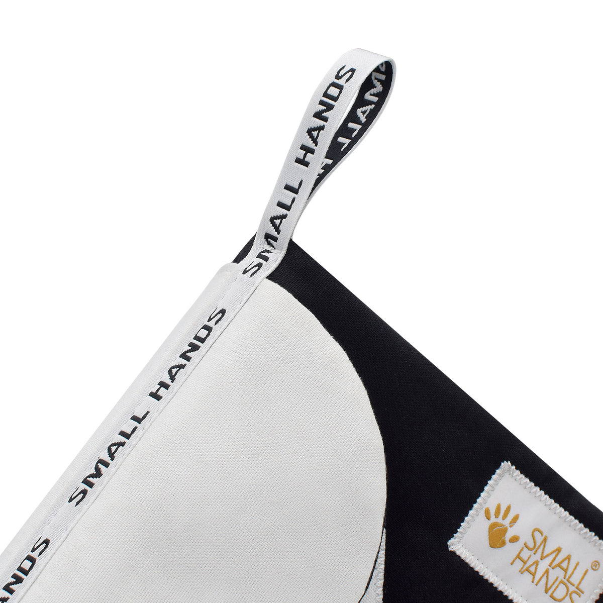 Small Hands Shapes book, close-up of the white Small Hands hanging loop and the contrast shape on black fabric