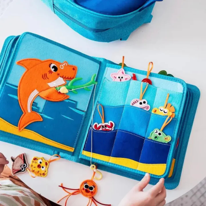 Baby Shark quiet book fishing page with shark figure and felt sea animals in pockets – develops fine motor skills from 3 years